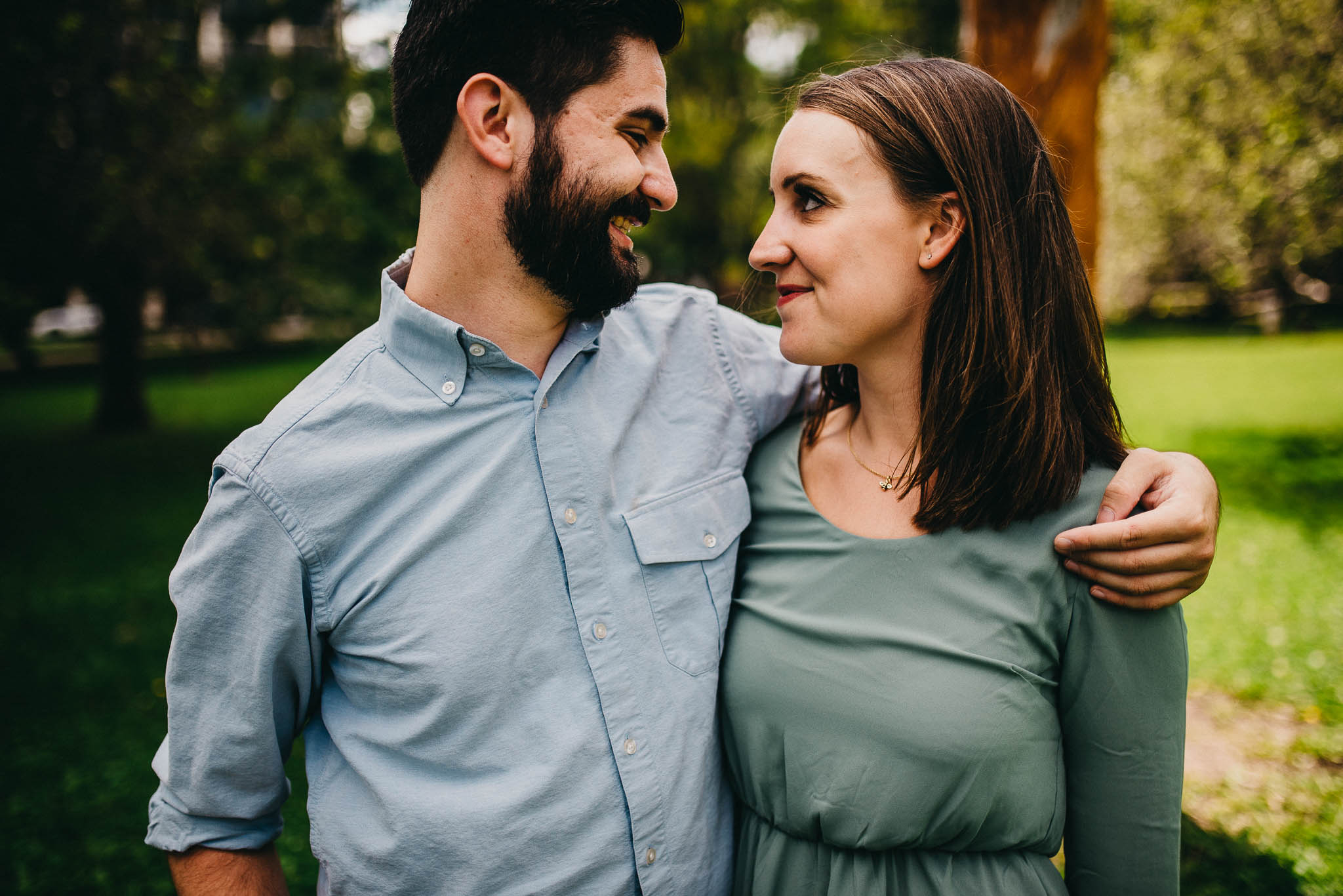 engaged couple smiling at each other