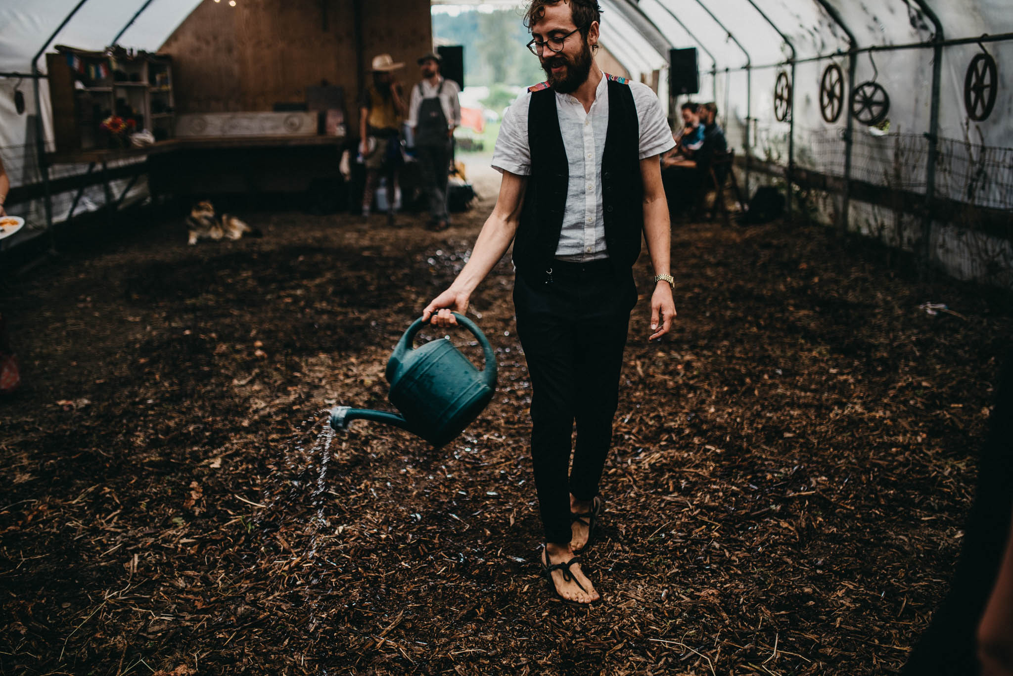 preparing dirt dance floor at farm wedding